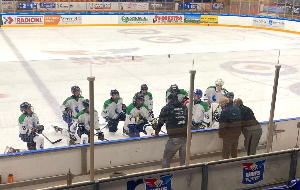Dordrecht Lions U17-lijn luistert aandachtig naar coach Bekker tijdens een time-out op het ijs in Heerenveen.