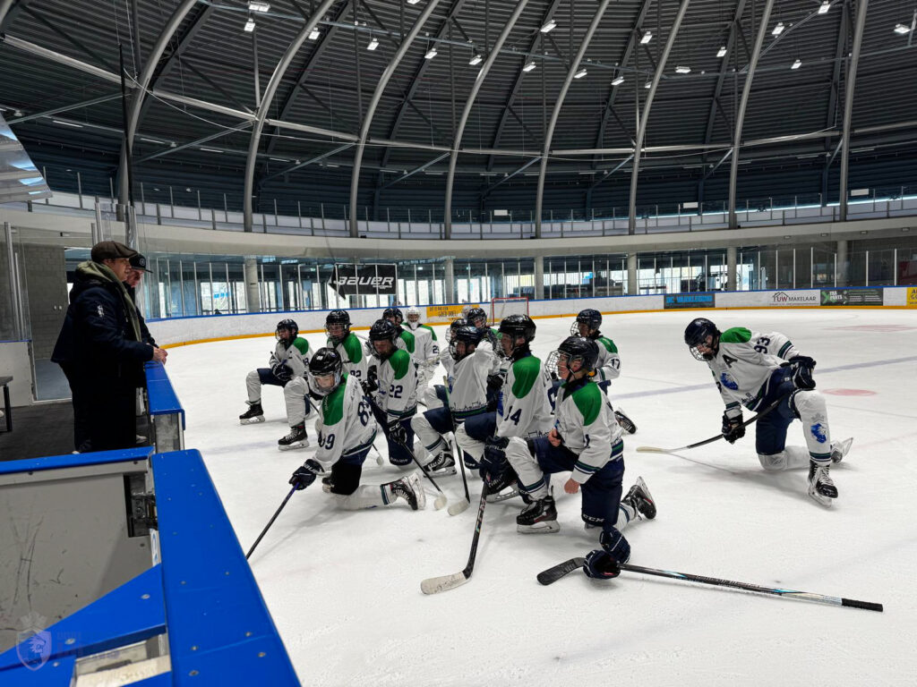 Coach geeft instructies aan Dordrecht Lions U15 spelers op het ijs in de Sportboulevard Dordrecht voorafgaand aan de wedstrijd.